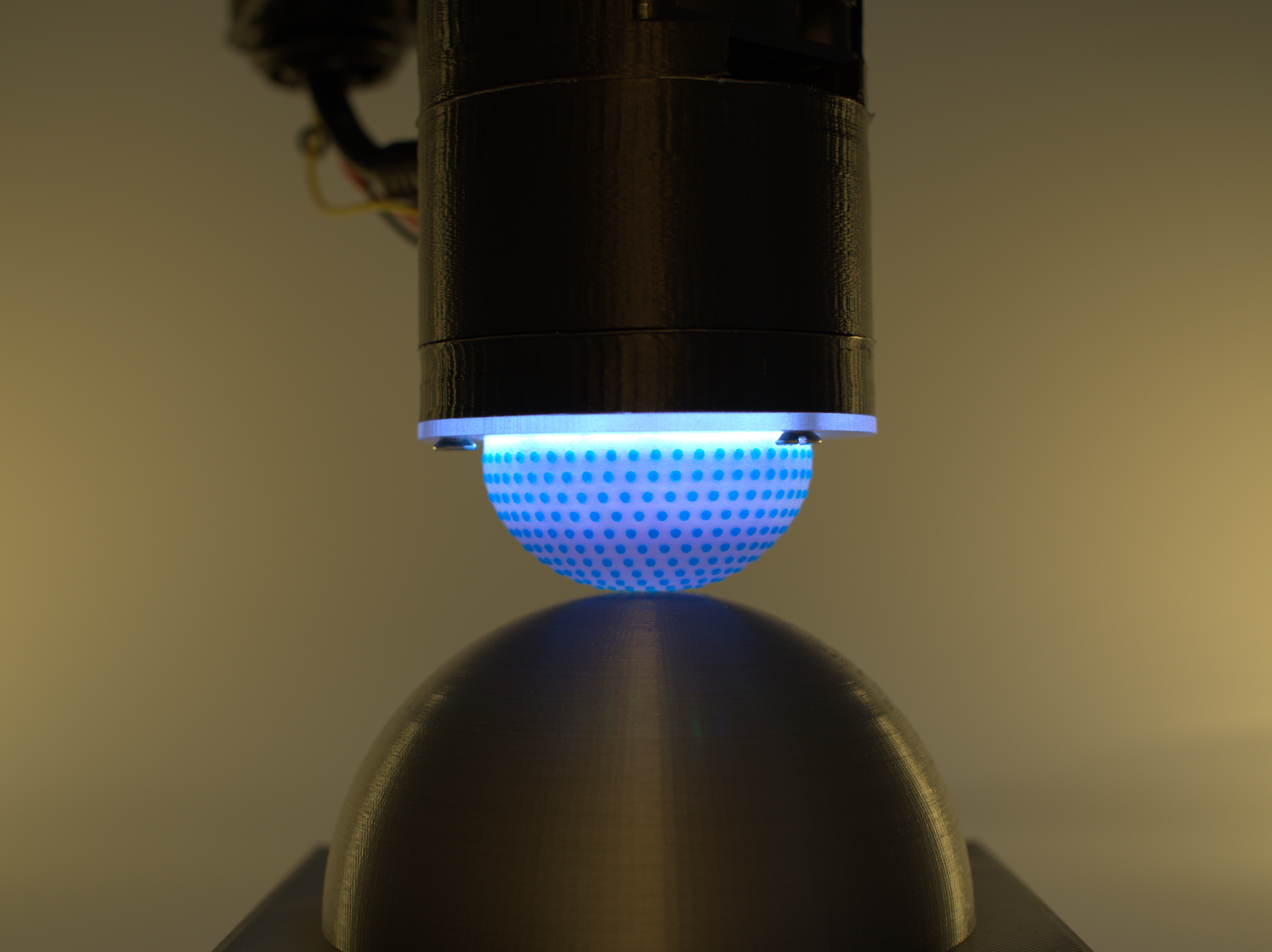 Curvature sensing with a spherical tactile sensor using the color-interference of a marker array